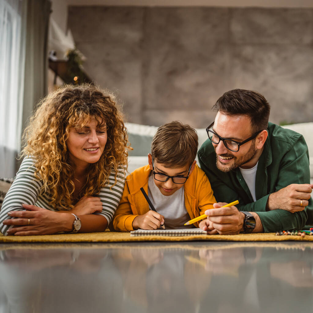 stock photo family three lie carpet draw home together